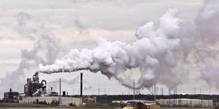 Deloitte says that without reduction in oil and gas output, an emissions cap is not feasible.